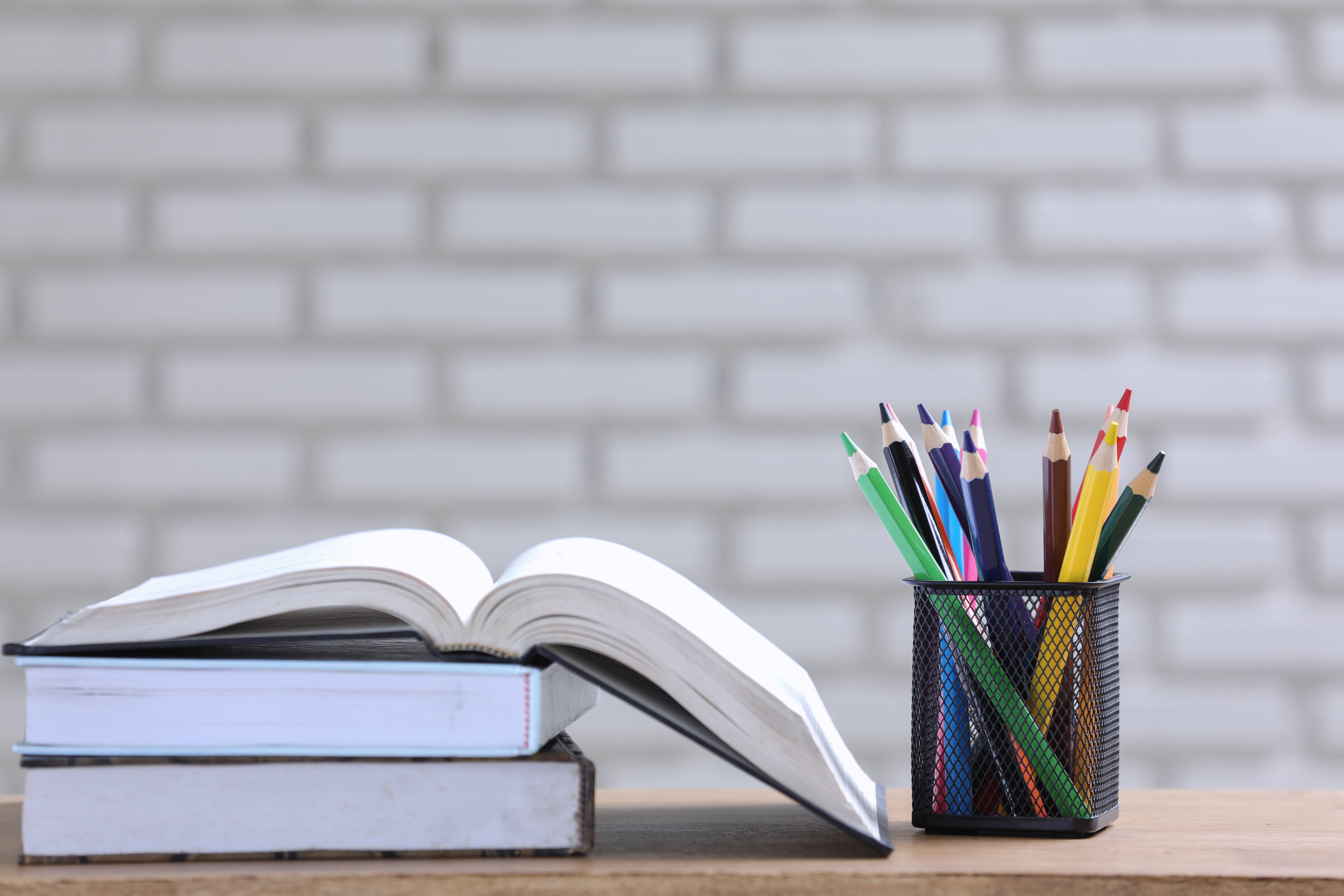 pile-of-books-and-pencils-on-the-desk